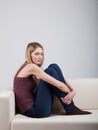 Girl sitting on the sofa Royalty Free Stock Photo