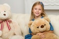 Girl Sitting On Sofa Hugging Teddy Bear