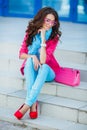 Girl sitting on stairs in colorful clothes Royalty Free Stock Photo