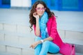 Girl sitting on stairs in colorful clothes Royalty Free Stock Photo