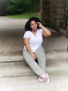 Portrait of a African American girl sitting on steps outide in Cleveland, Ohio