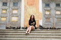 Girl sitting on the steps of the old walls