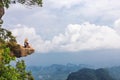 Girl sitting at the stone rock. Picturesque observation point