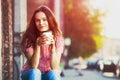 Girl sitting in street with coffee Royalty Free Stock Photo