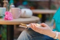 Girl sitting at summer terrace in street with morning coffee and reading book Royalty Free Stock Photo