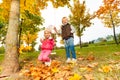 Girl sitting on swings and blond boy standing near Royalty Free Stock Photo