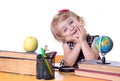 Girl sitting at table with books and globe Royalty Free Stock Photo