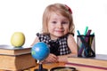 Girl sitting at table with books and globe Royalty Free Stock Photo