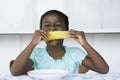 Girl (5-6) sitting at table eating corn cobb Royalty Free Stock Photo