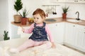 Child littered in flour in the kitchen