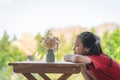 Girl sitting table with a jar of flower for children love nature concept Royalty Free Stock Photo