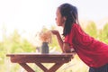 Girl sitting on table with a jar of flower for children love nature concept Royalty Free Stock Photo