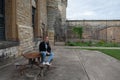 girl sitting at a table in the main courtyard of Old Joliet Prison, a former abandoned jail