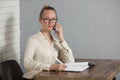 Girl is sitting at a table with a pen Royalty Free Stock Photo