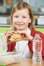 Girl Sitting At Table In School Cafeteria Eating Healthy Packed Royalty Free Stock Photo