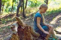 Girl sitting on a tree stump Royalty Free Stock Photo