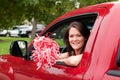 Girl Sitting in Truck with Pom Pom