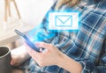 Girl is sitting on the white bed. Young woman is searching information in internet. Missing mail message window from smartphone Royalty Free Stock Photo