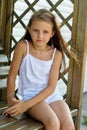 Girl sitting on a wooden bench Royalty Free Stock Photo