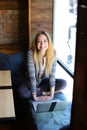 Girl sitting on wooden chair.