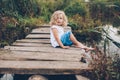 girl sitting on a wooden pier