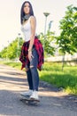 Girl skateboarder - sporty legs skateboarding in park