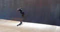 Girl skateboarding on vert ramp in the sunshine sharp shadow Royalty Free Stock Photo