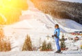 Girl skier against ski slopes and ski-lift on background Royalty Free Stock Photo