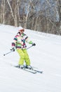 Girl skier coming down the slope on sunny day Royalty Free Stock Photo