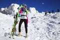 Girl skier enjoys the ski resort. Beautiful woman in winter outfit is posing with skis in the mountains. Winter sports. Skiing Royalty Free Stock Photo