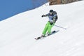 Girl skier rides steep mountains. Russia, Far East, Kamchatka