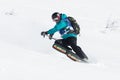 Girl skier rides steep mountains. Russia, Far East, Kamchatka Peninsula
