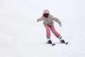 Girl skiing from the mountain in winter