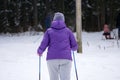 Girl skiing during snowfall weather ski resort Skier wears a blue winter coat, purple hot pants, blue shorts and white gloves. The Royalty Free Stock Photo