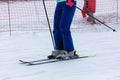 A girl skis on the snow in winter