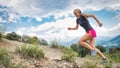 Girl skyrunner uphill on a running trail Royalty Free Stock Photo