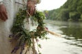 The girl in Slavic clothes with a wreath on the background of the river Royalty Free Stock Photo