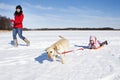 Girl sledding with dog