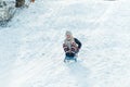 A girl with sledge. Beautiful teenage girl having fun outside in a wood with snow in winter. active life consept