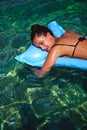 Girl sleeping on air bed floating in water