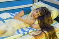 Girl sleeping in a crib with a fluffy cat Royalty Free Stock Photo
