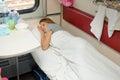 Girl sleeping in a train compartment on lower second-class place car Royalty Free Stock Photo
