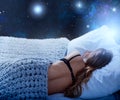 Girl sleeps in a cozy bed during the night with space background. Concept of relax and rest. Royalty Free Stock Photo