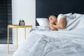 The girl sleeps next to the alarm clock. Time to wake up. On the wake-up clock 7 a.m. Deep sleep Royalty Free Stock Photo