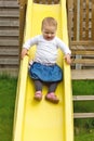 Girl sliding on playground Royalty Free Stock Photo