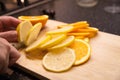 A girl is slitting a lemon. Close-up.