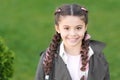 Girl small kid with fashionable braids hairstyle. Fashion trend. Salon and hair care. Girl cute smile face outdoors