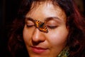 Girl with a small orange butterfly sitting on her face. Royalty Free Stock Photo