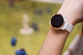 Girl with smart watch playing role game dungeons and dragons, the green field at the background