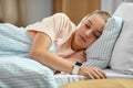 girl with smart watch sleeping in bed at home